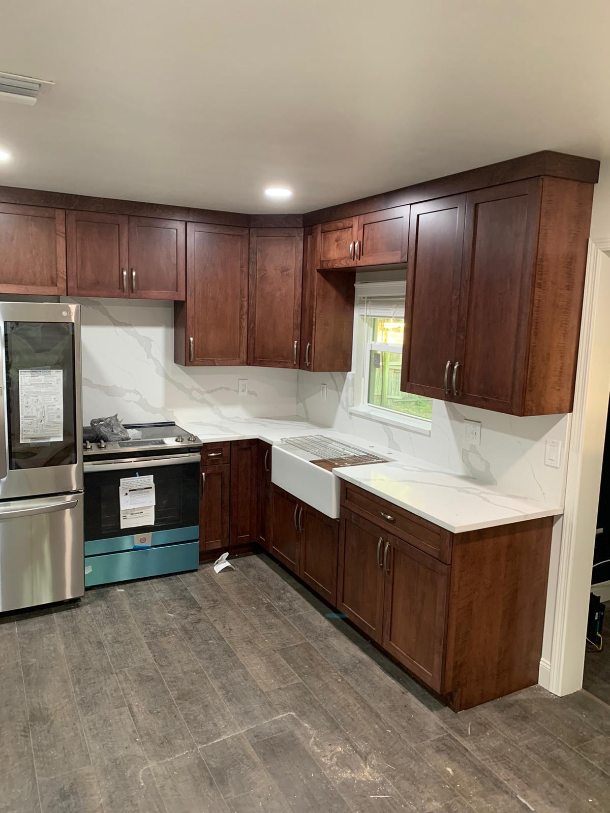 Wood-tone kitchen · Installation in progress: A place for the everyday.